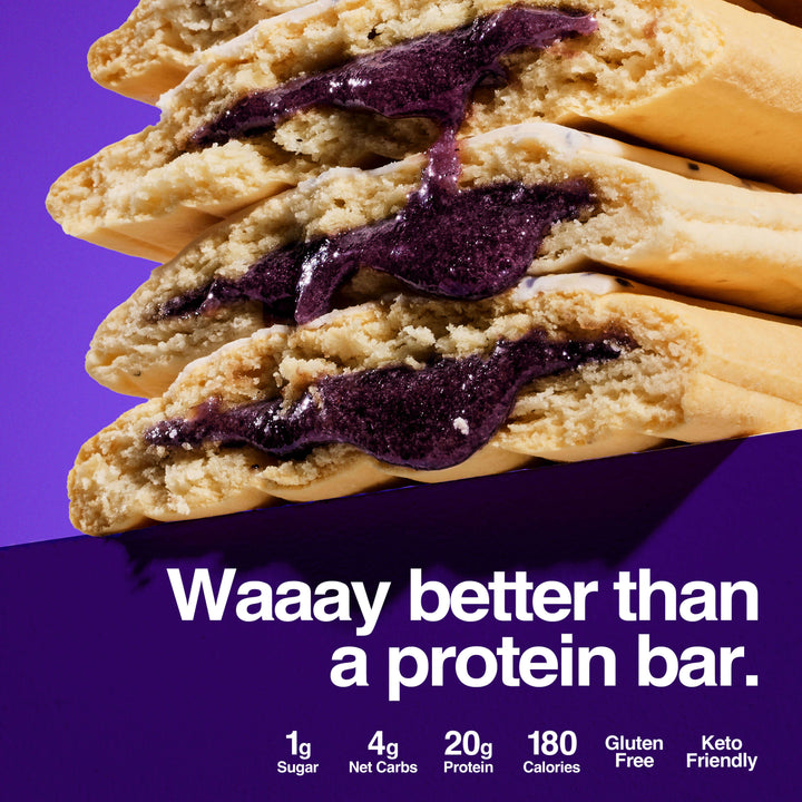 Stack of blueberry pastries with purple filling, labeled 'Waaay better than a protein bar,' 20g protein, and 4g net carbs.