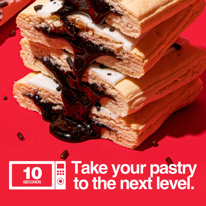 Image of stacked and gooey hot fudge sundae protein pastries. Text with microwave icon that reads "take your pastry to the next level" with a 10 second microwave icon.