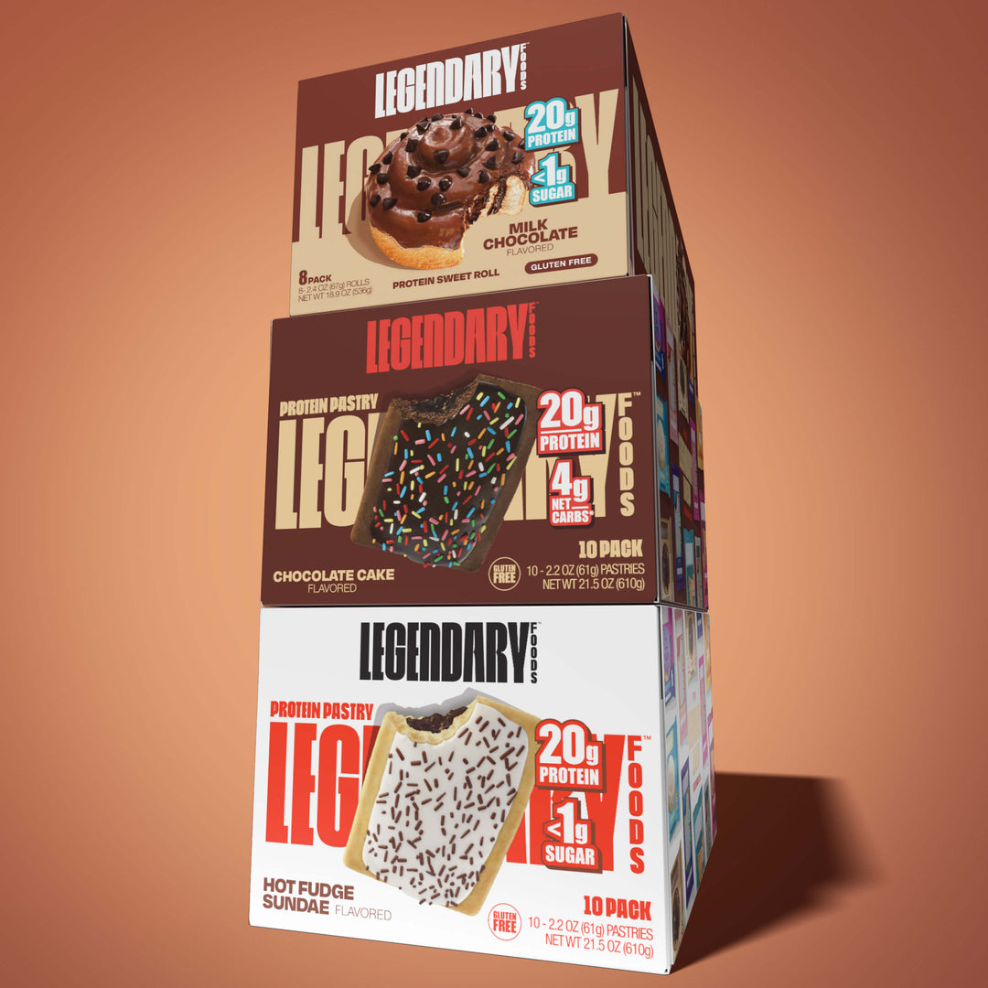 Stacked boxes of Legendary Foods chocolate snacks: sweet roll, chocolate cake pastry, and hot fudge sundae pastry.