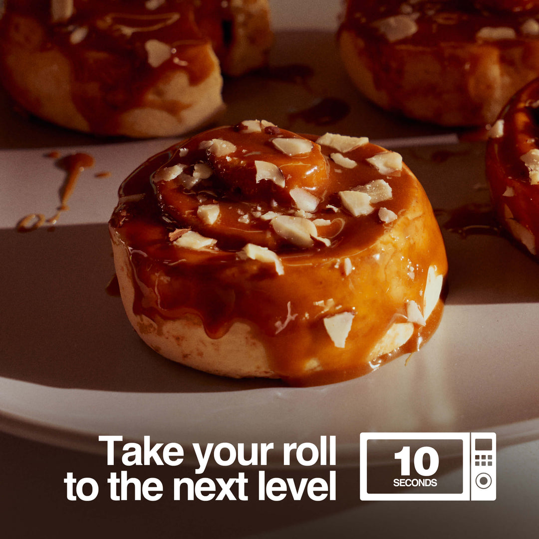 Warm caramel sticky bun on a plate with text reading “Take your roll to the next level – 10 seconds” beside a microwave icon.