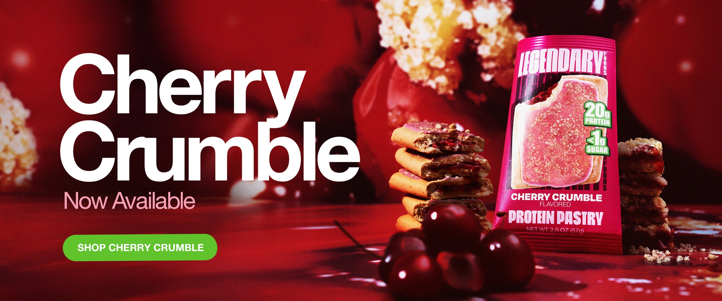 Cherry Crumble Protein Pastry now available. A stack of cherry-filled pastries with a bright red package in front, showcasing '20g protein' and '<1g sugar' labels. A green button reads 'Shop Cherry Crumble.'