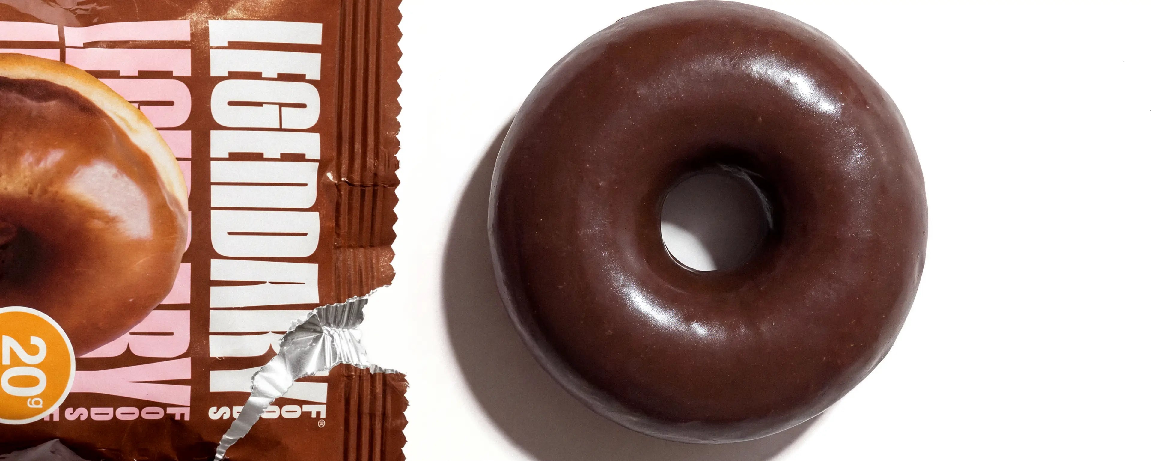 Chocolate donut with a package labeled 'Legendary' on a white background