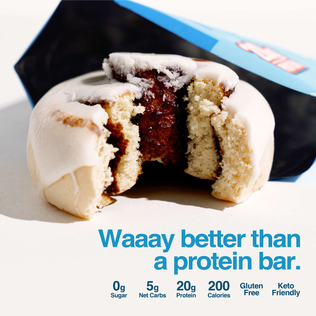 Cinnamon Protein Roll with white icing and chocolate filling. Text: "Waaay better than a protein bar."