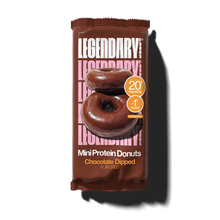 A single packaged mini protein donut on a plain white background with a cast shadow. The wrapper is dark brown and prominently shows the brand name LEGENDARY, an image of two chocolate-dipped donuts, and text reading 'Mini Protein Donuts' and 'Chocolate Dipped'.