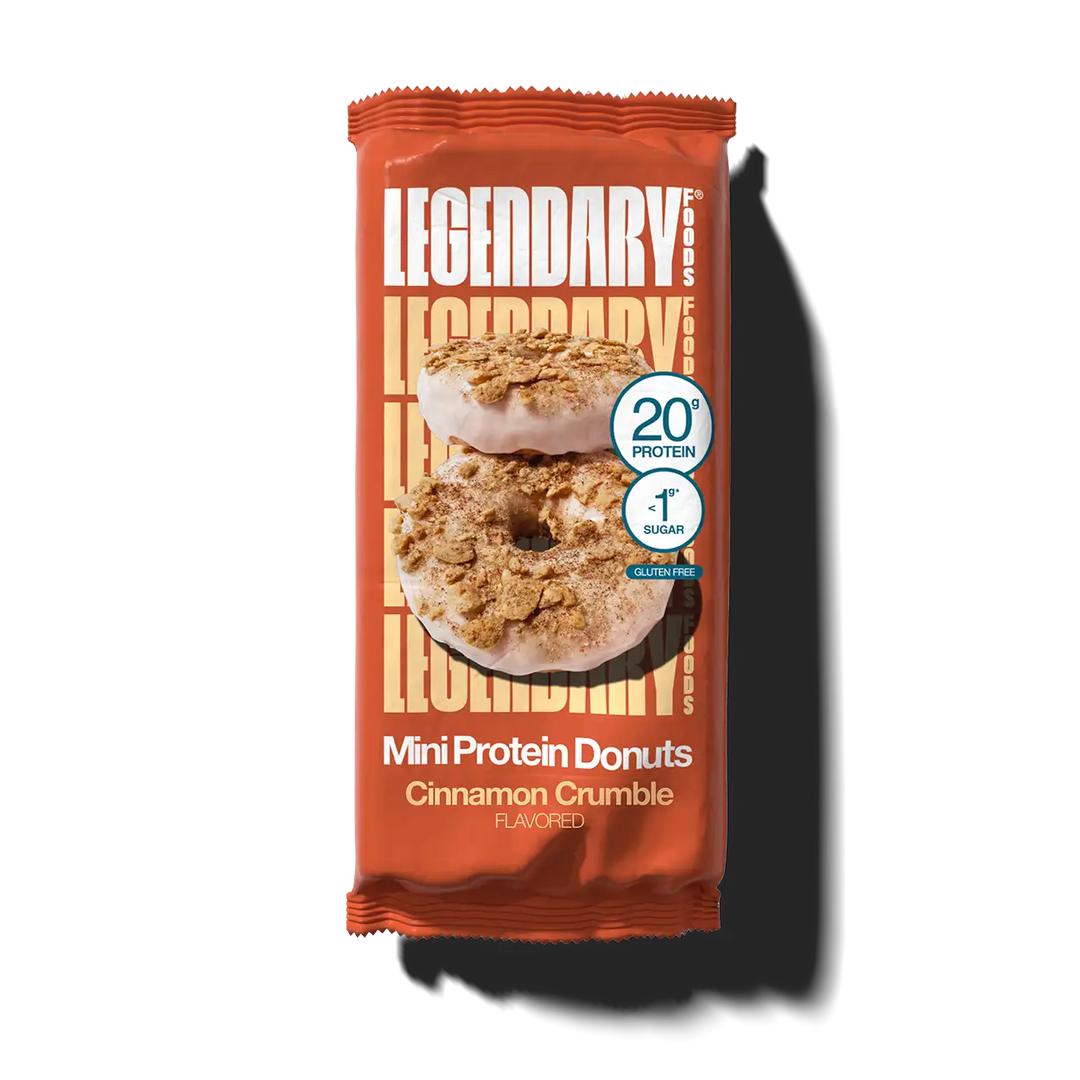 Legendary Foods Cinnamon Crumble Mini Protein Donuts in an orange wrapper, featuring two glazed donuts topped with cinnamon crumbles. Contains 20g protein and less than 1g sugar.
