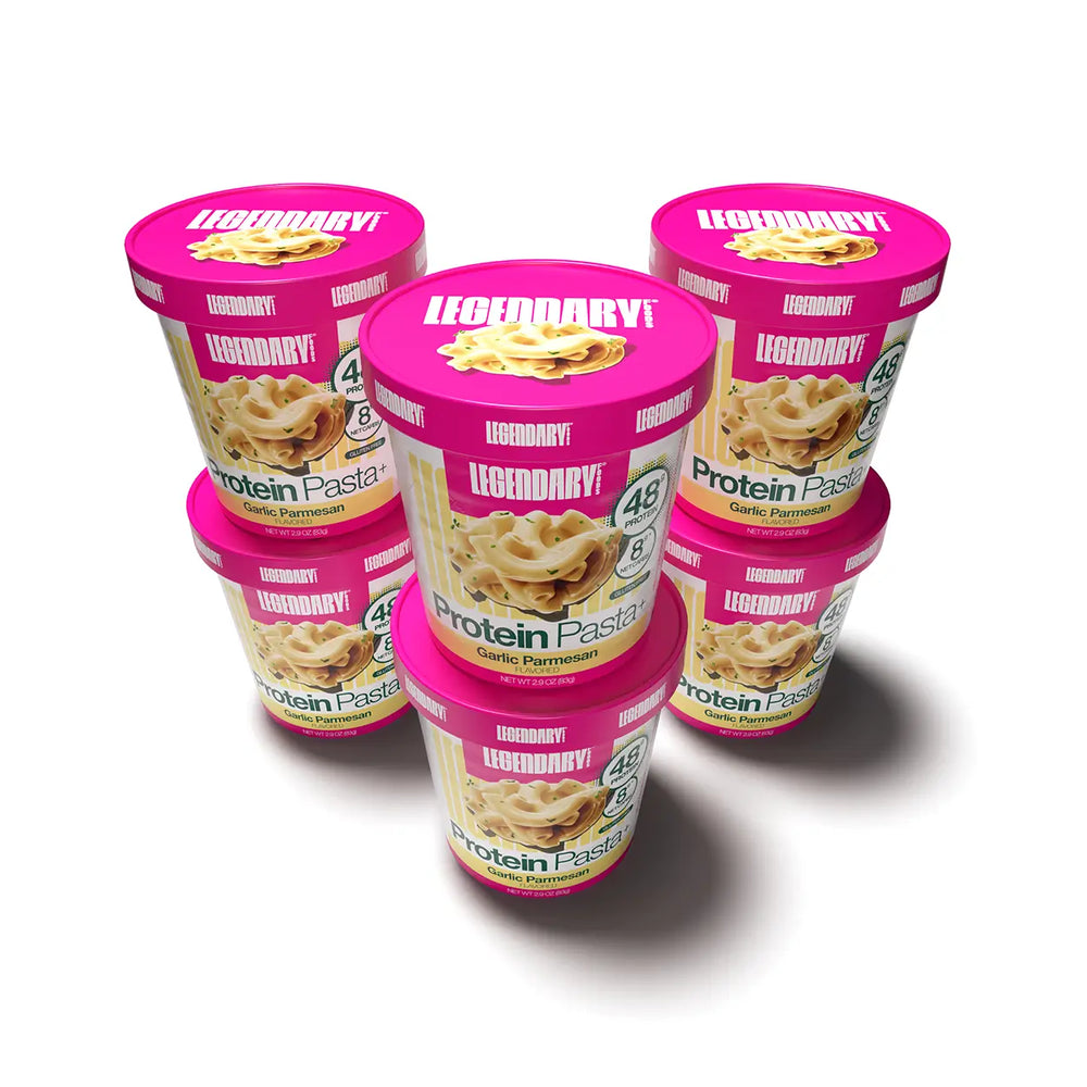Six Legendary Foods Protein Pasta Garlic Parmesan cups arranged in a pyramid formation on a light background with pink lids visible.
