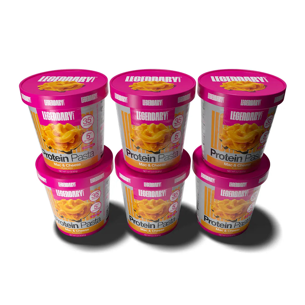 Six Legendary Protein Pasta Mac & Cheese cups stacked in two rows with magenta lids and product labels visible