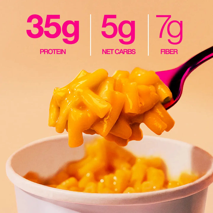 Close-up of mac and cheese on spoon with text highlighting 35g protein, 5g net carbs, and 7g fiber