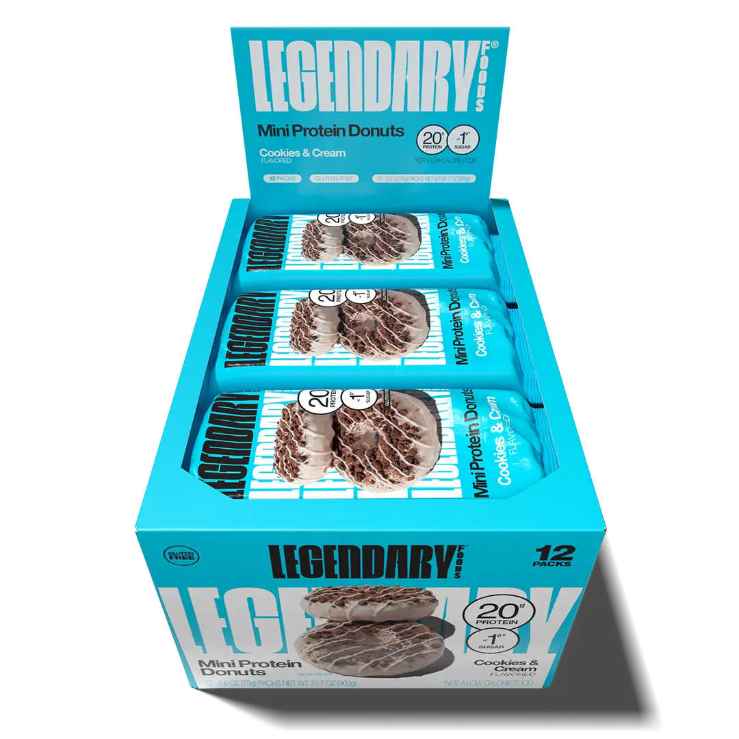 Open 12-pack box of Legendary Foods Cookies & Cream Mini Protein Donuts with individually wrapped donut packs inside.