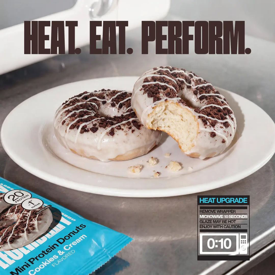 Legendary Foods Cookies & Cream Mini Protein Donuts on a plate, including one cut open to show the interior, with 10-second microwave heating instructions.