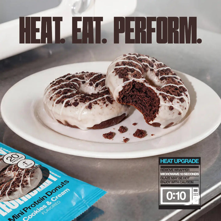Legendary Foods Cookies & Cream Mini Protein Donuts on a plate, including one cut open to show the interior, with 10-second microwave heating instructions.