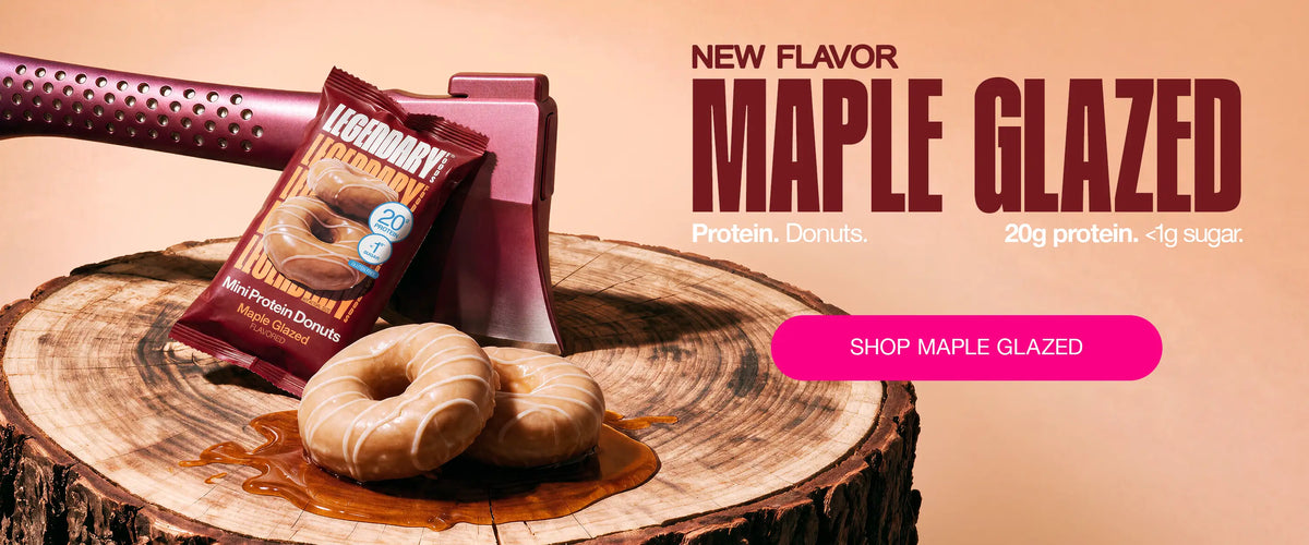 Legendary Foods Maple Glazed Mini Protein Donuts on a tree stump with product packaging and an axe. New flavor with 20g protein and less than 1g sugar.