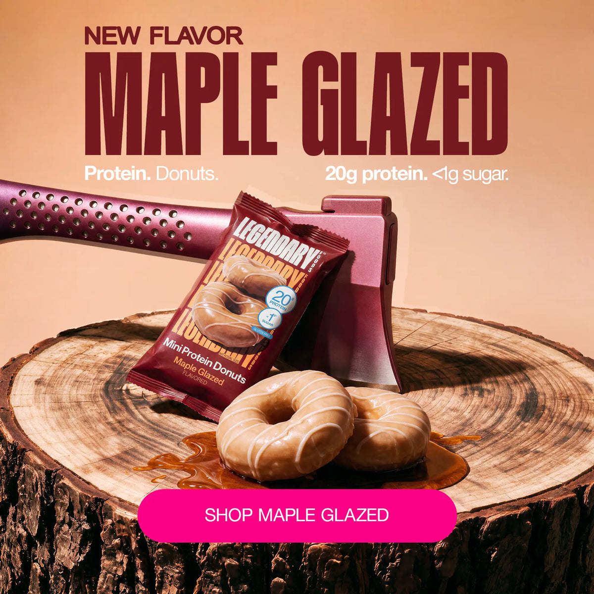 Legendary Foods Maple Glazed Mini Protein Donuts on a tree stump with product packaging and an axe. New flavor with 20g protein and less than 1g sugar.