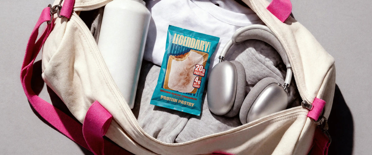 Legendary Brown Sugar Cinnamon Protein Pastry in an open gym bag with headphones and a water bottle.