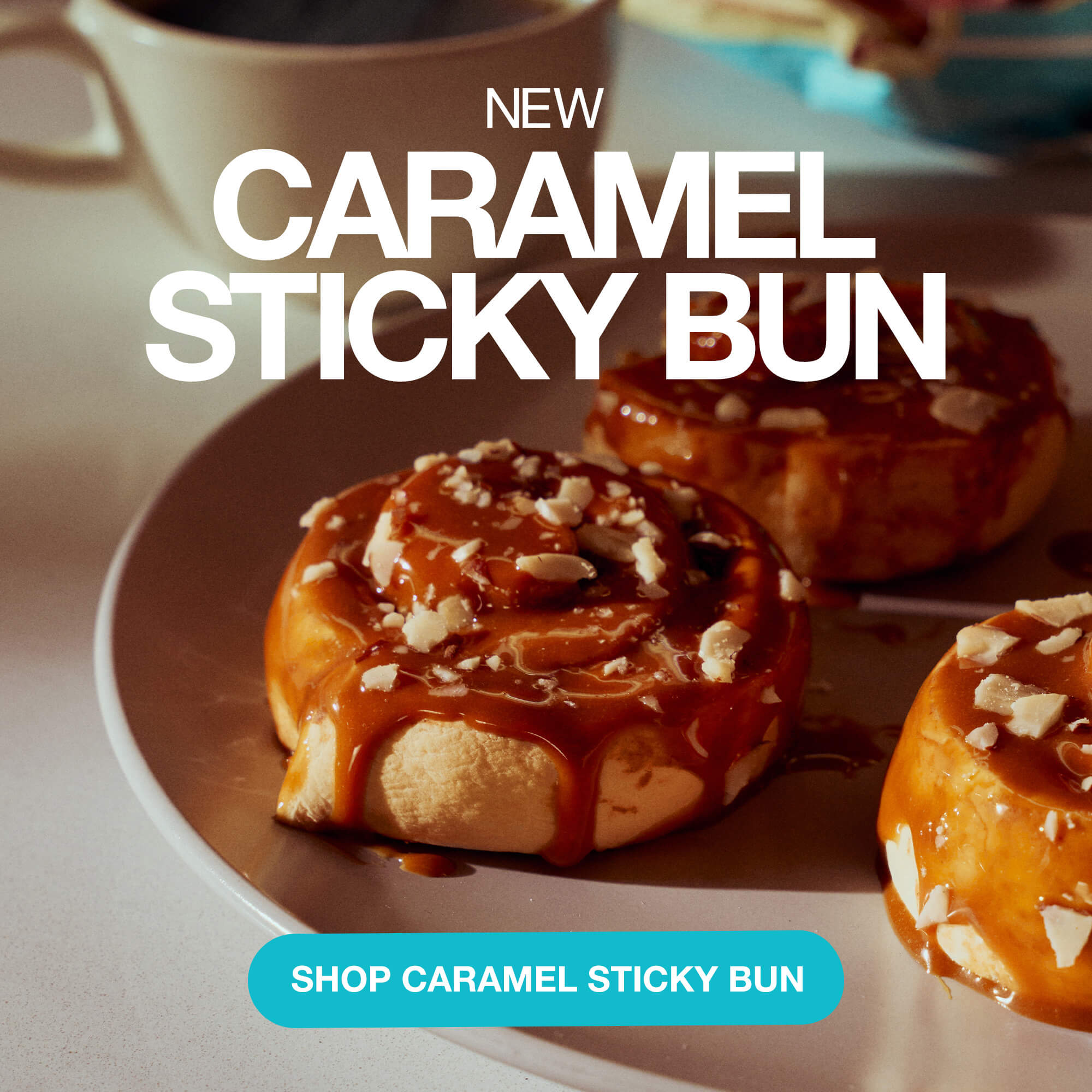 Close-up of caramel sticky buns on a plate with text reading “New Caramel Sticky Bun” and a blue button that says “Shop Caramel Sticky Bun.”