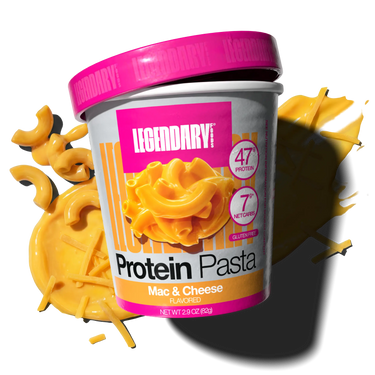 Cup of Legendary Protein Pasta Mac & Cheese with pasta noodles and cheese sauce in the background